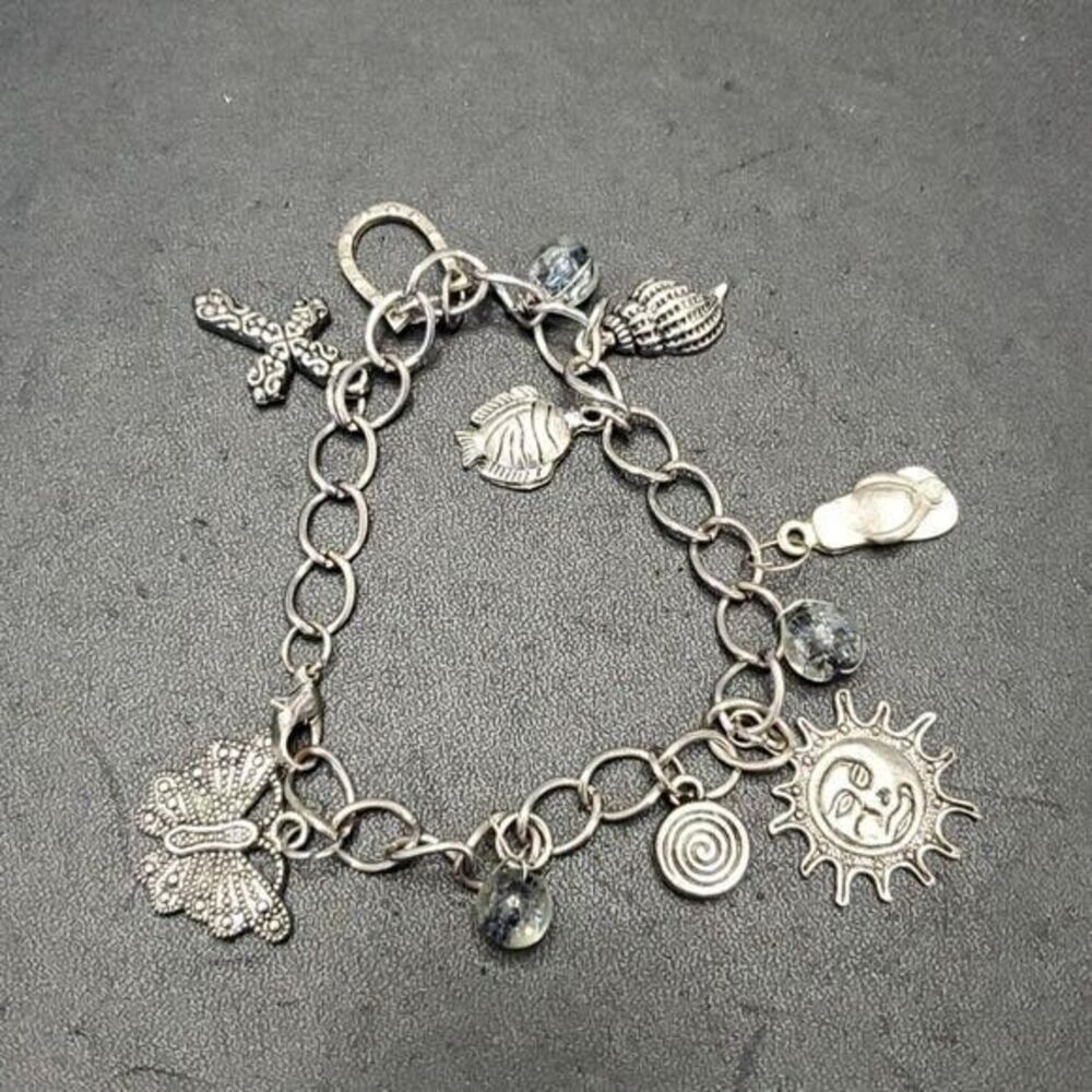 Silver tone charm bracelet sun fish cross shell